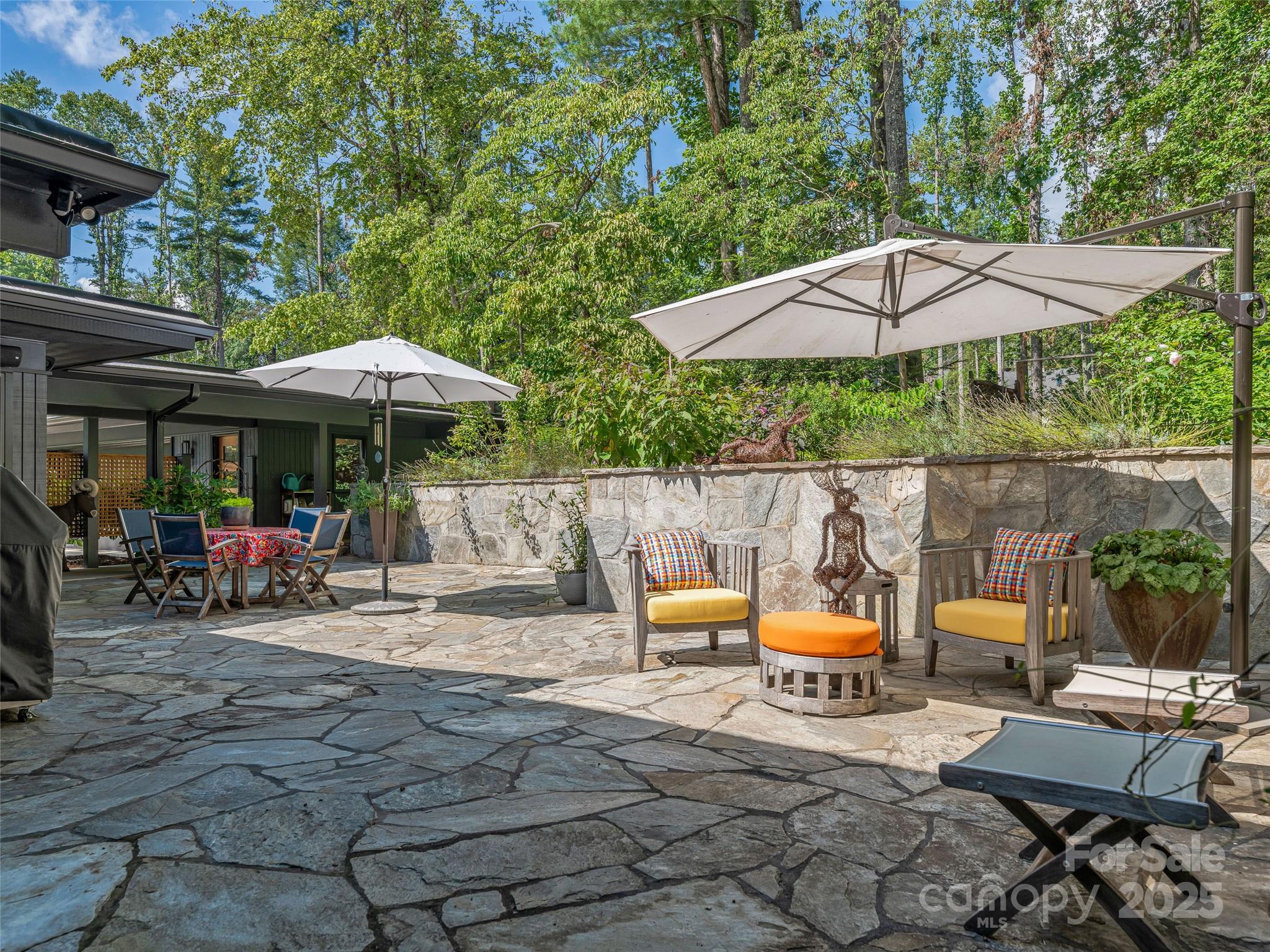 5 Brookside Road Asheville, NC 28803 - Photo 19 of 45 a couple of tables and chairs under an umbrella in backyard of a house