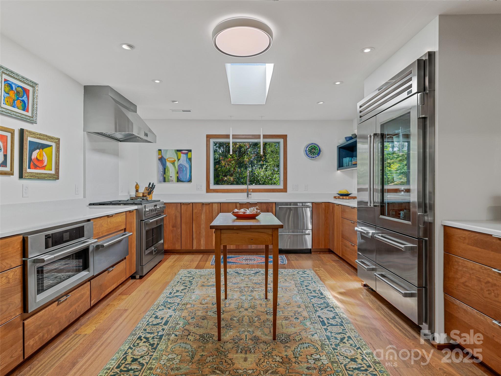 5 Brookside Road Asheville, NC 28803 - Photo 22 of 45 a kitchen with stainless steel appliances kitchen island granite countertop a stove a sink and a refrigerator