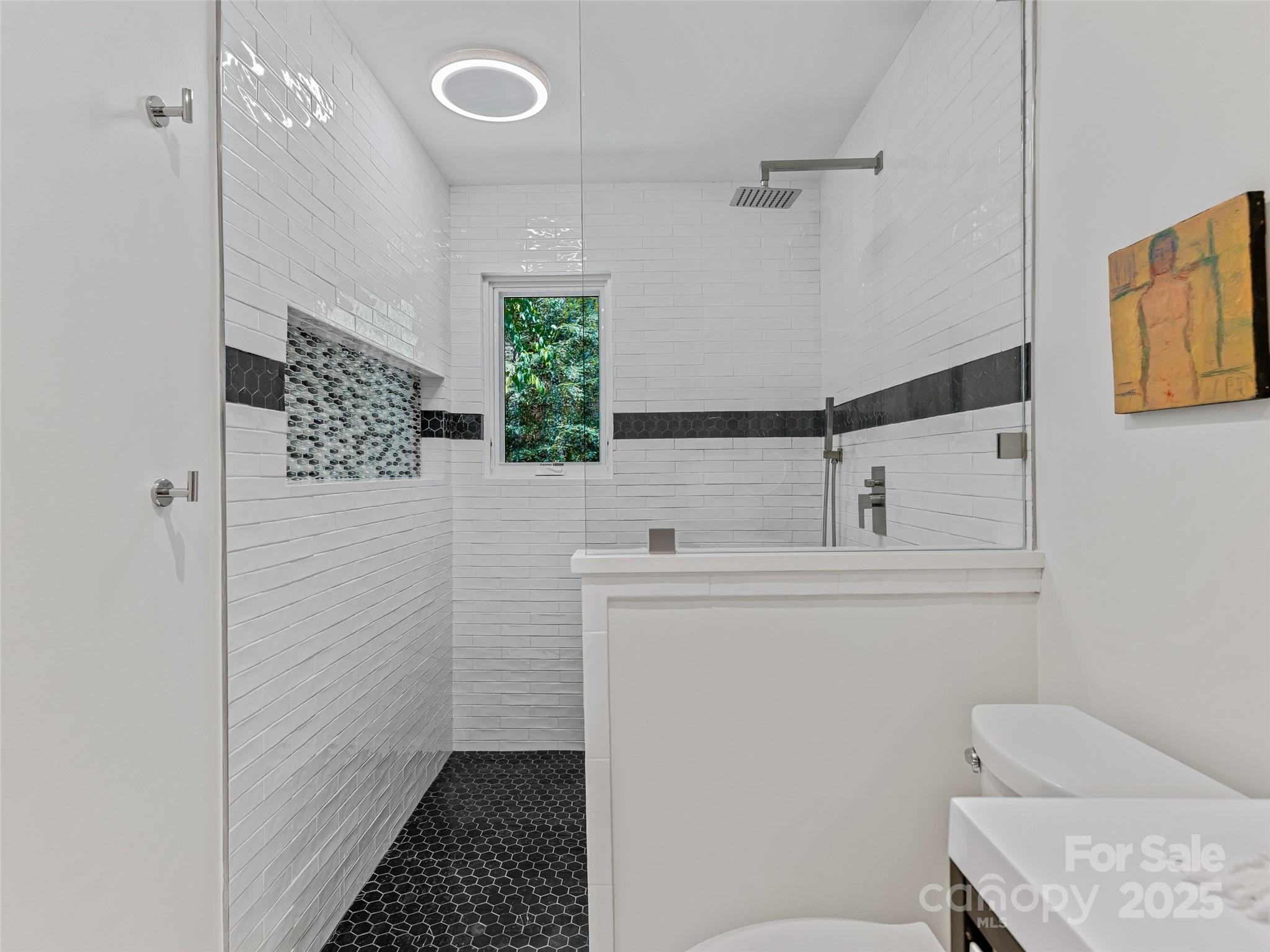 5 Brookside Road Asheville, NC 28803 - Photo 38 of 45 a bathroom with a sink a toilet and shower