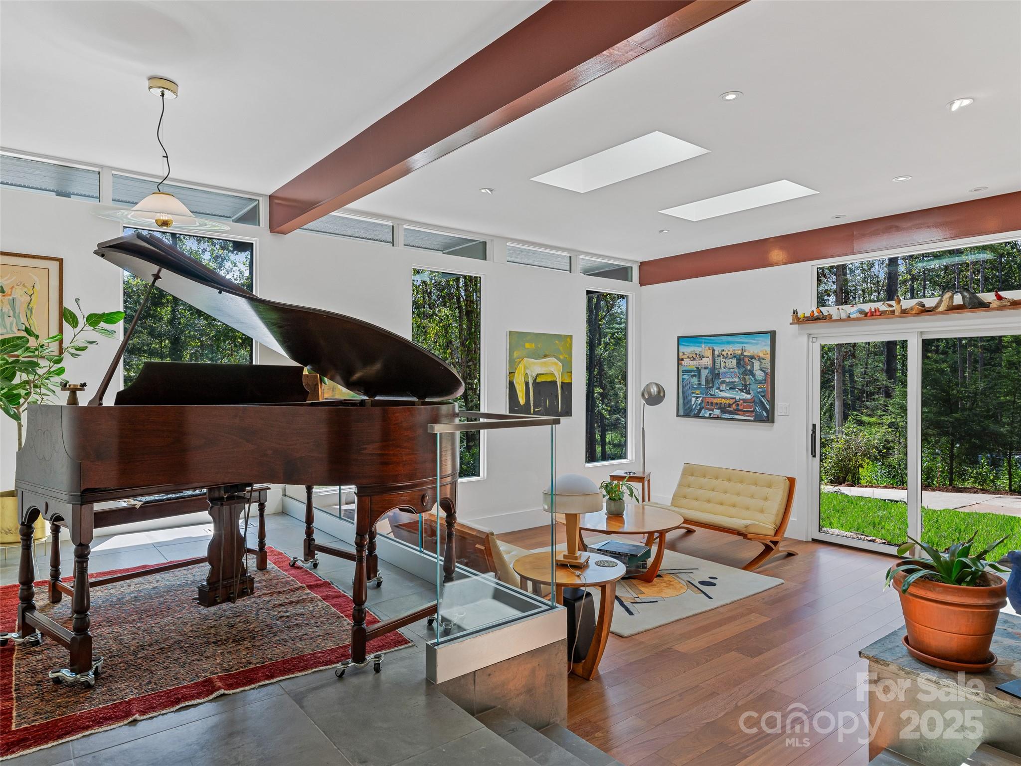 5 Brookside Road Asheville, NC 28803 - Photo 5 of 45 a living room with patio furniture and a potted plant