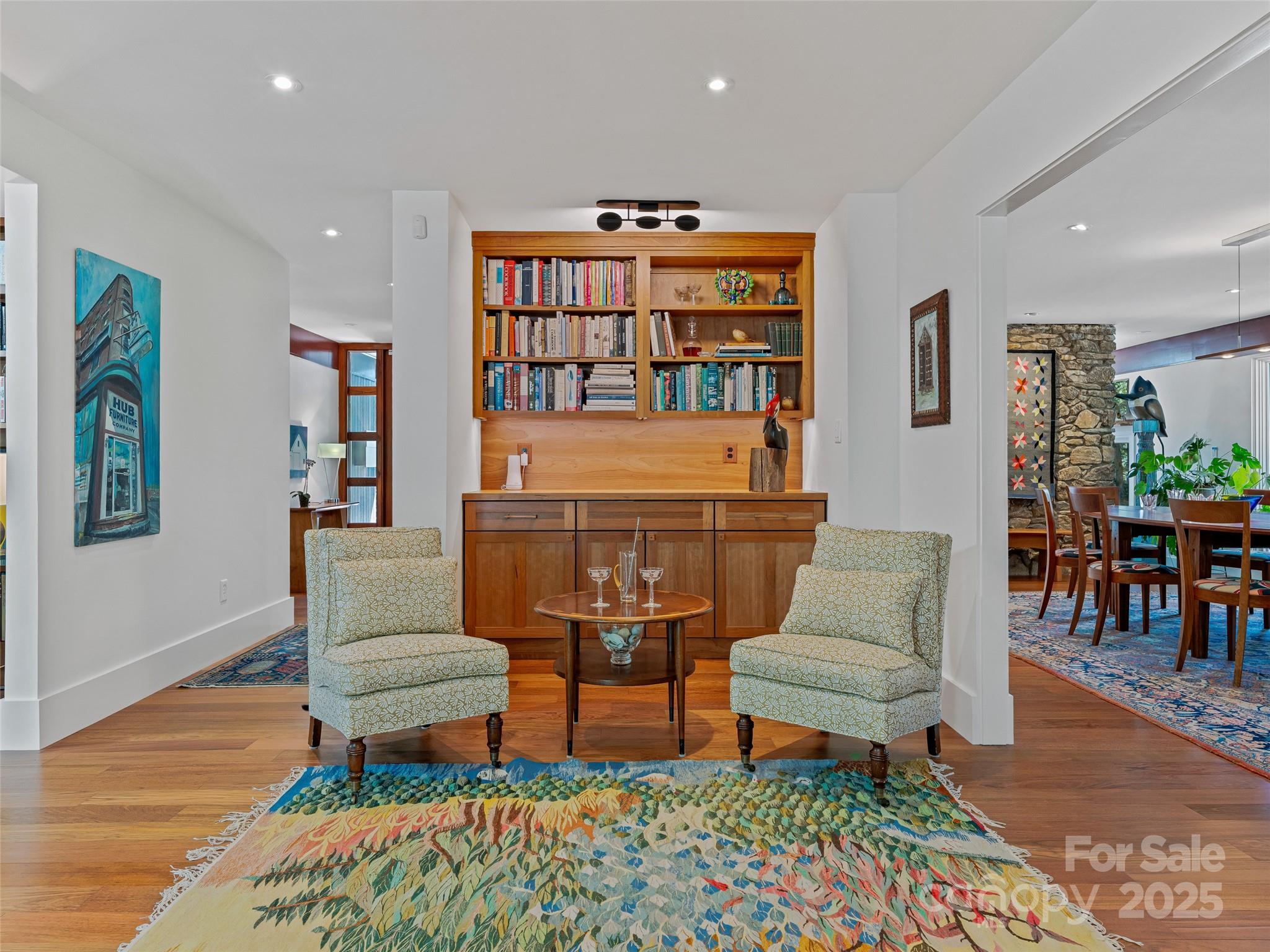 5 Brookside Road Asheville, NC 28803 - Photo 10 of 45 a living room with furniture a rug and a bookshelf