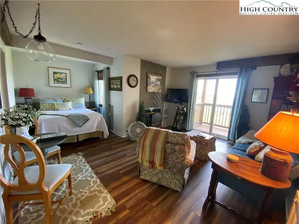 a bedroom with bed and glass windows