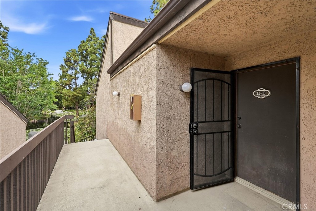 7890 East Spring Street, Unit 11E Long Beach, CA 90815 - Photo 8 of 40 a view of a door and wooden floor in front of house