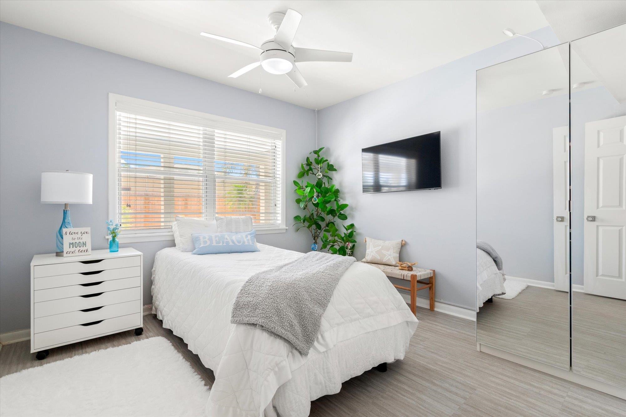 78 Ferrol Road St. Augustine, FL 32084 - Photo 30 of 59 a bedroom with a bed a couch and a flat tv screen