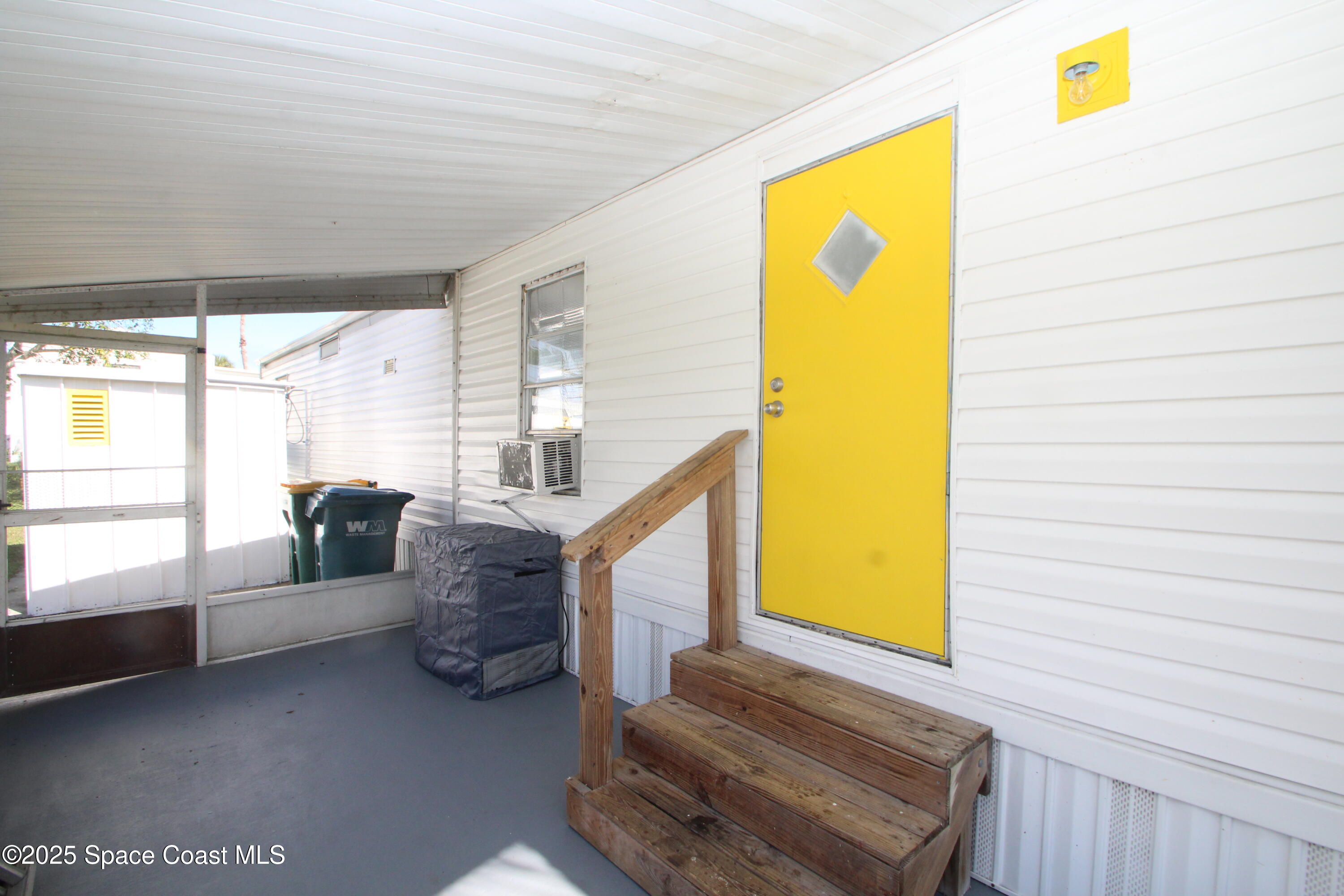 2132 Rocway Drive Melbourne, FL 32935 - Photo 2 of 8 a living room with furniture and a gate