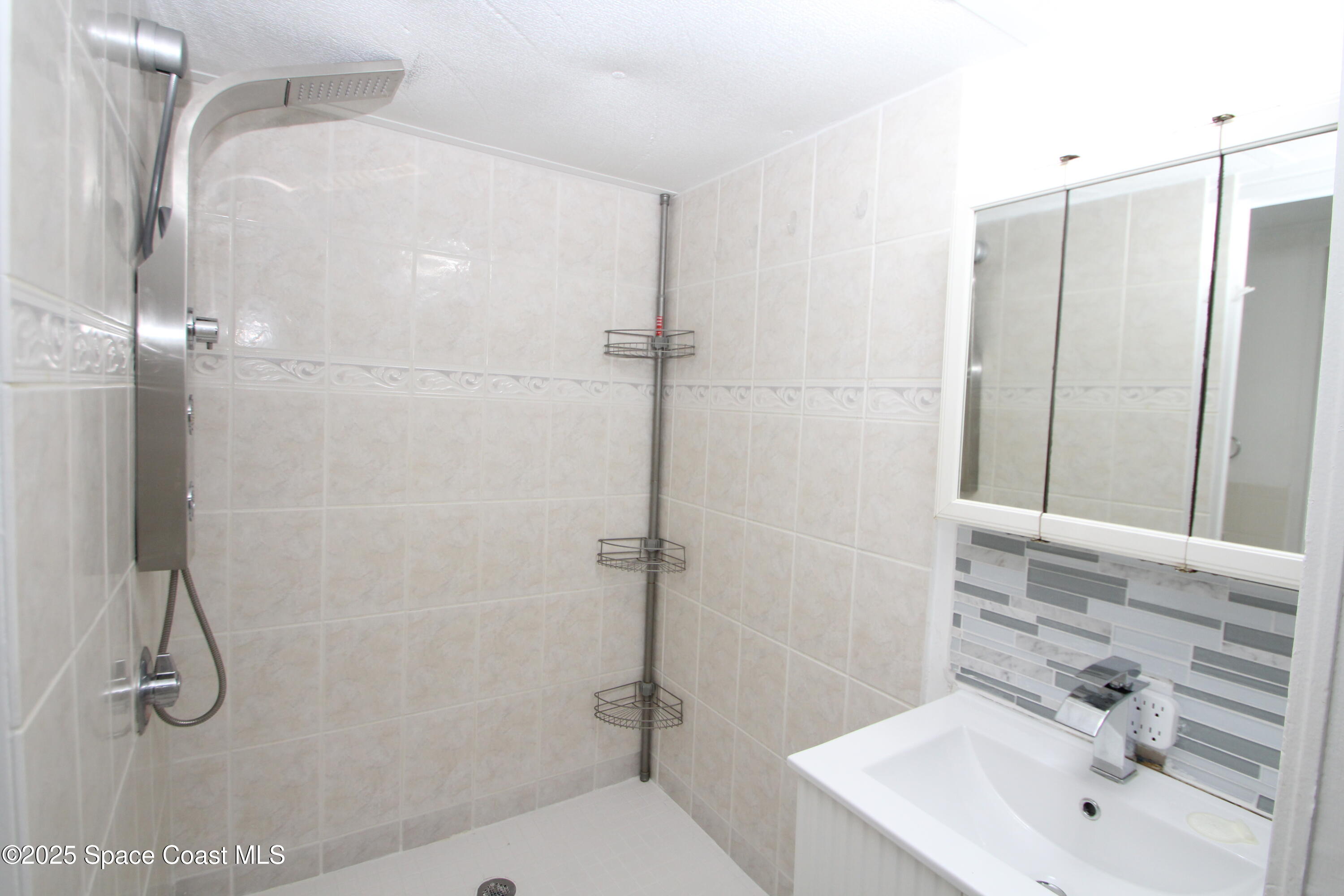 2132 Rocway Drive Melbourne, FL 32935 - Photo 7 of 8 a bathroom with a sink a toilet and shower