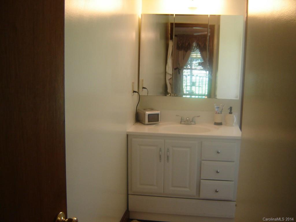 1007 Mills Harris Road Wingate, NC 28174 - Photo 15 of 24 a bathroom with a sink and a mirror