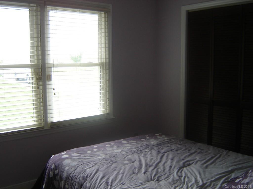 1007 Mills Harris Road Wingate, NC 28174 - Photo 18 of 24 a bed sitting in a bedroom next to a window