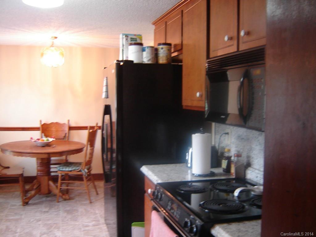 1007 Mills Harris Road Wingate, NC 28174 - Photo 8 of 24 a kitchen with a stove and a refrigerator