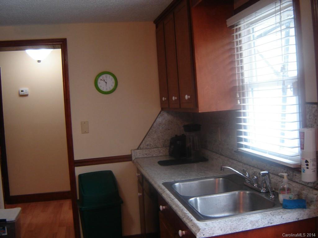 1007 Mills Harris Road Wingate, NC 28174 - Photo 9 of 24 a kitchen with a sink a refrigerator and window