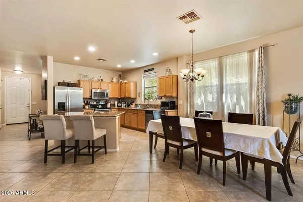 a dining area with a table chairs and entryway