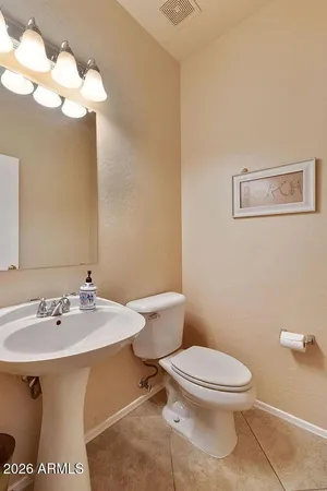 a white toilet sitting next to a bathroom sink