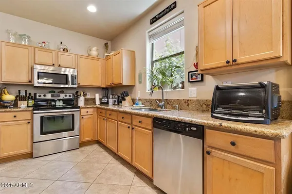 a kitchen with stainless steel appliances a stove a sink and a microwave