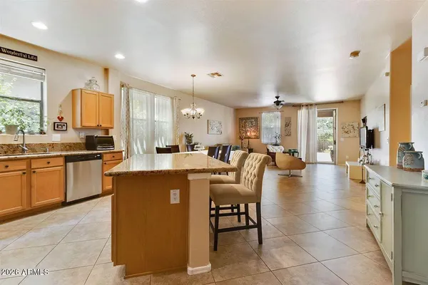 a large kitchen with a table and chairs