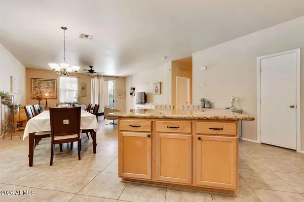 a kitchen with cabinets and chairs