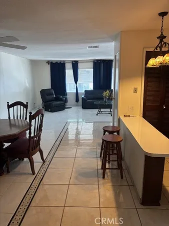 a lobby with furniture and a flat screen tv