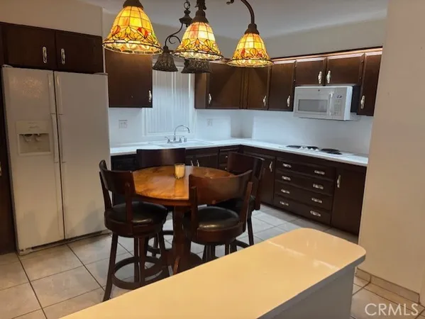 a kitchen with stainless steel appliances wooden cabinets and a sink