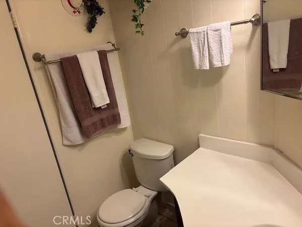 a white toilet sitting next to a small sink