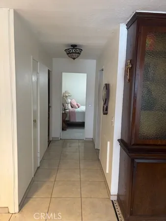 a view of a hallway to a livingroom and a couch