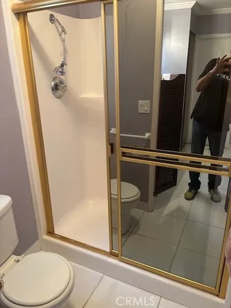 a bathroom with a toilet and a shower