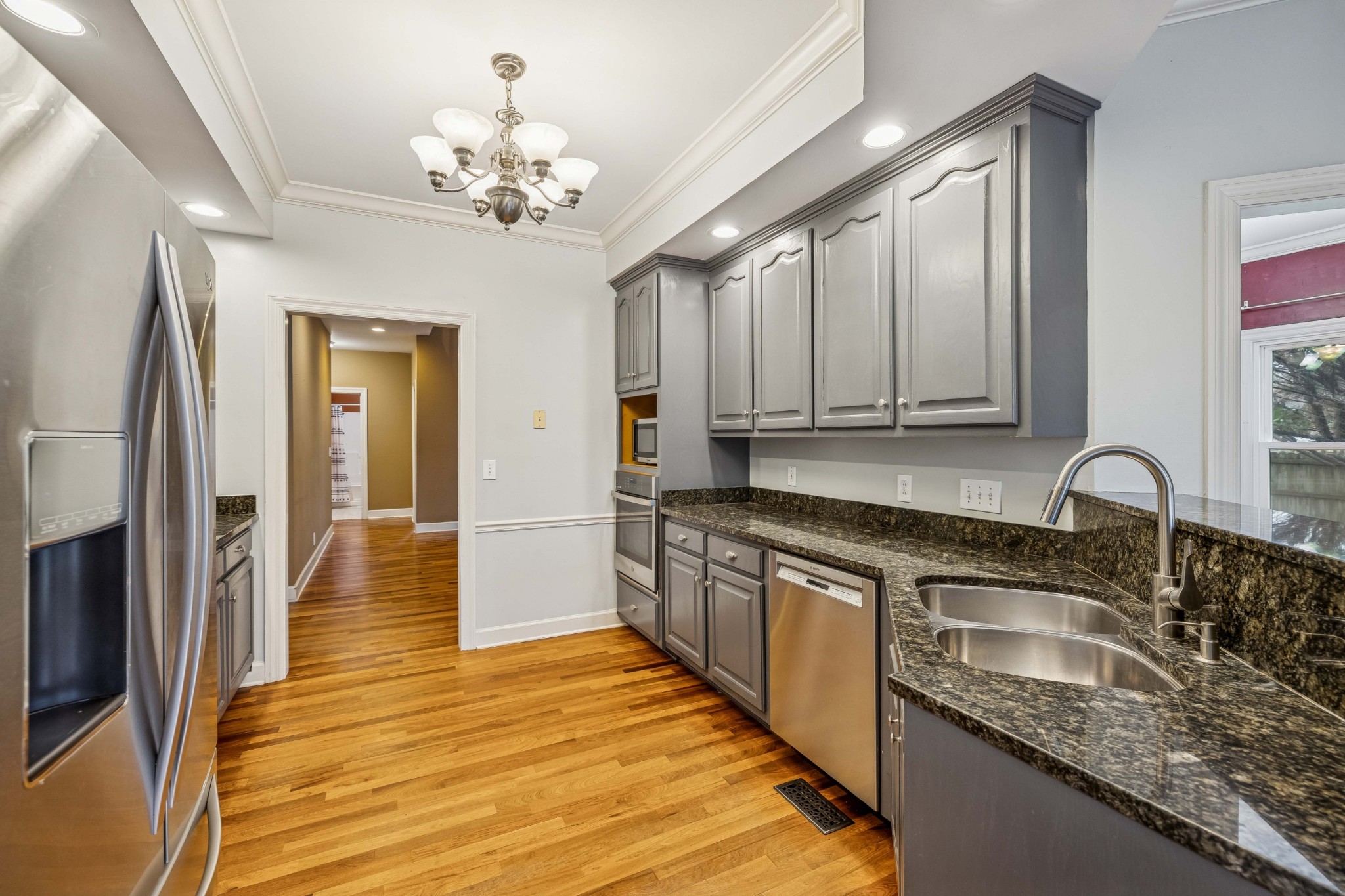 2815 Bowers Lane Murfreesboro, TN 37129 - Photo 42 of 75 a kitchen with stainless steel appliances granite countertop a sink and dishwasher a stove top oven with wooden floor