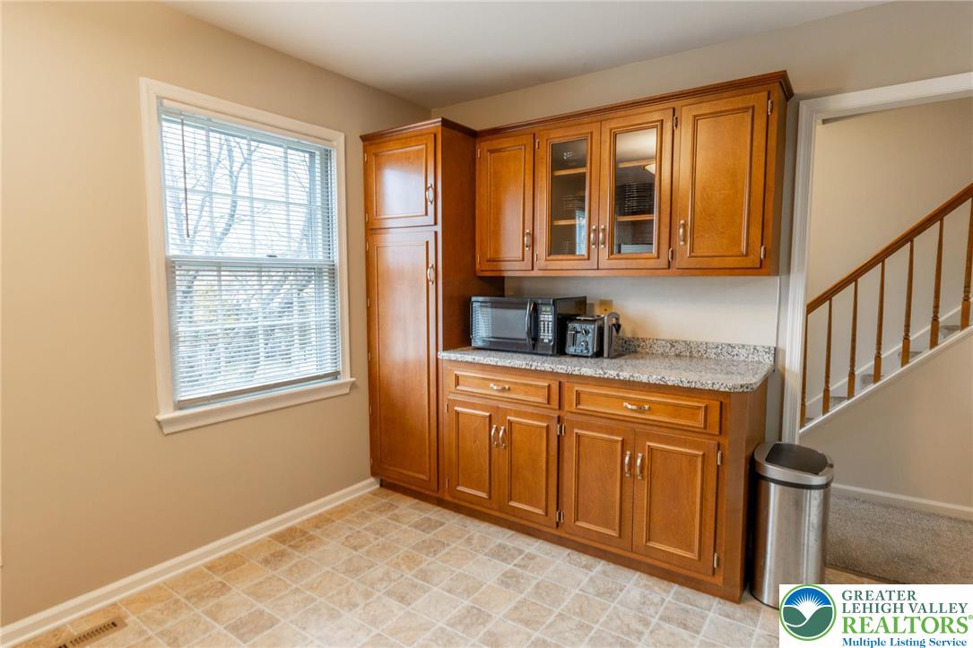 1049 Barnside Road Allentown, PA 18103 - Photo 7 of 19 a kitchen with granite countertop wooden cabinets a sink and a window