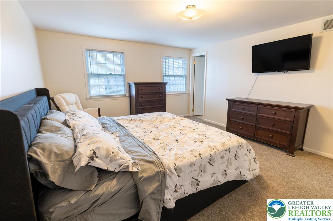 1049 Barnside Road Allentown, PA 18103 - Photo 10 of 19 a bedroom with a bed and a flat screen tv