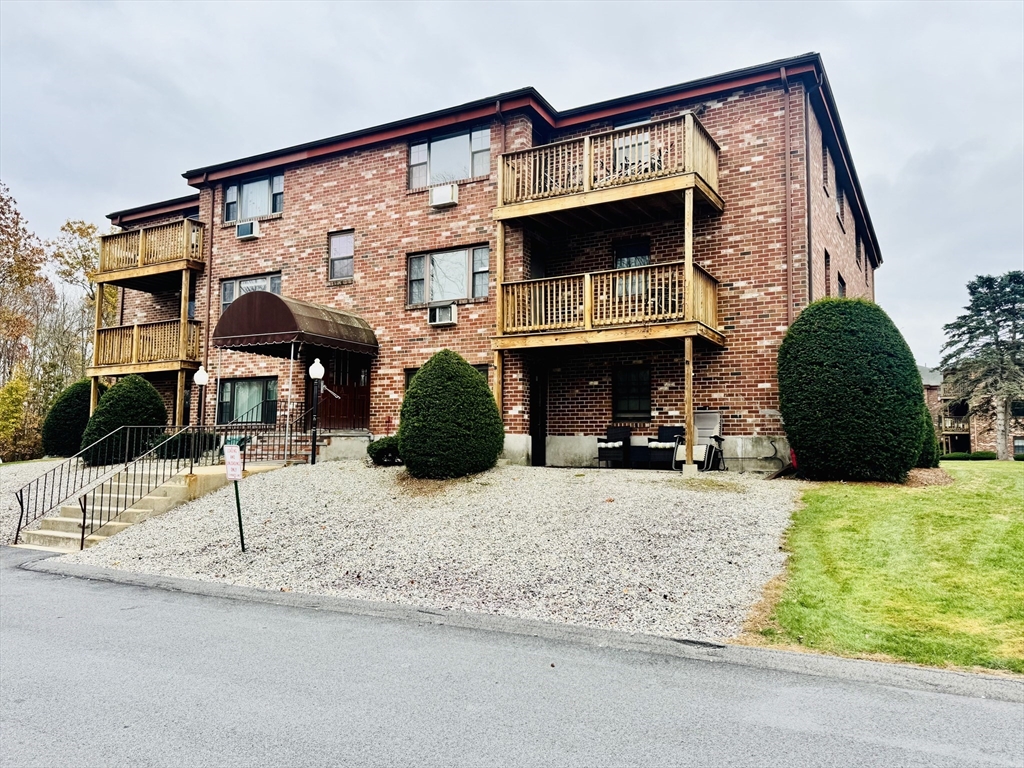a view of building with car parked
