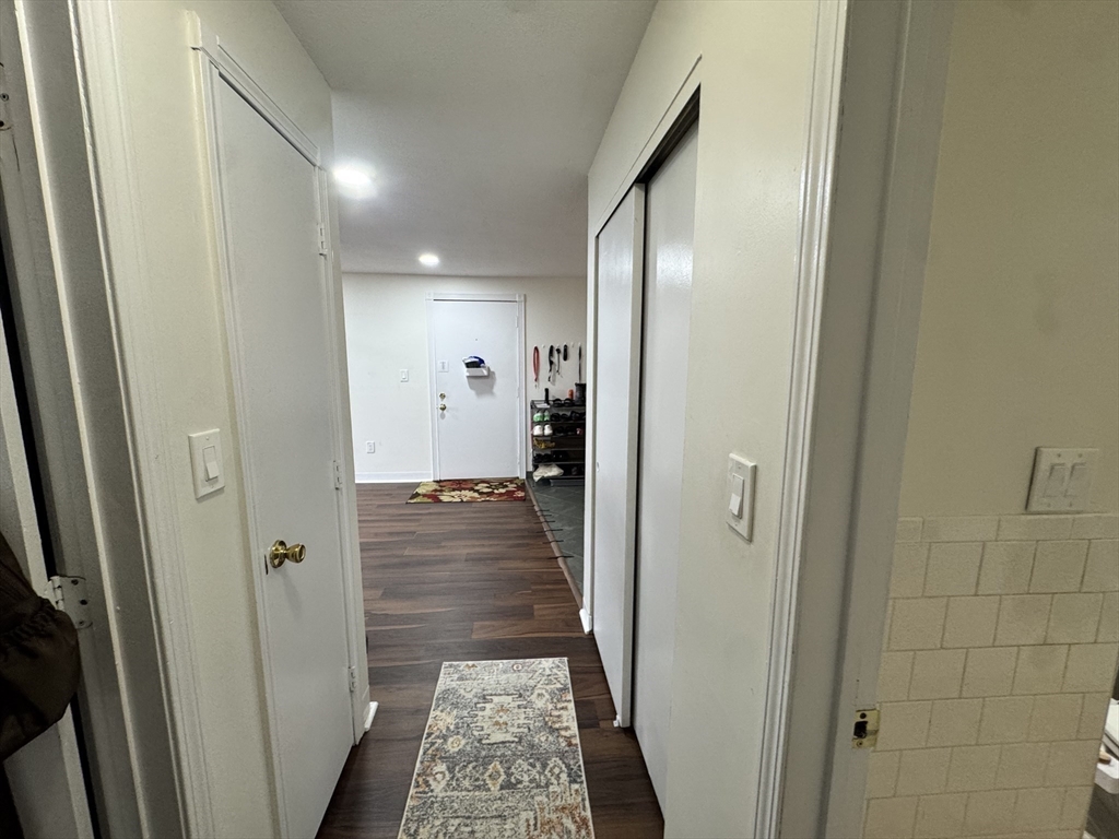 14 A Mayberry Drive, Unit 10 Westborough, MA 01581 - Photo 12 of 25 a view of a hallway with wooden floor and a bathroom