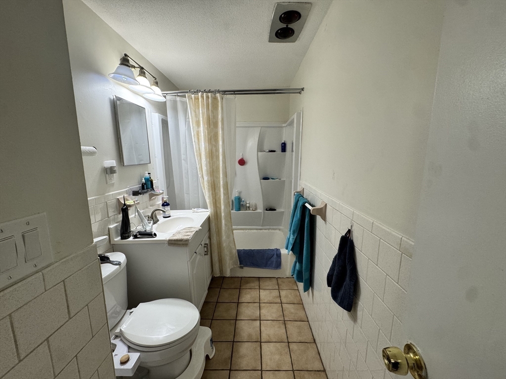 14 A Mayberry Drive, Unit 10 Westborough, MA 01581 - Photo 14 of 25 a bathroom with a sink a toilet a mirror and shower