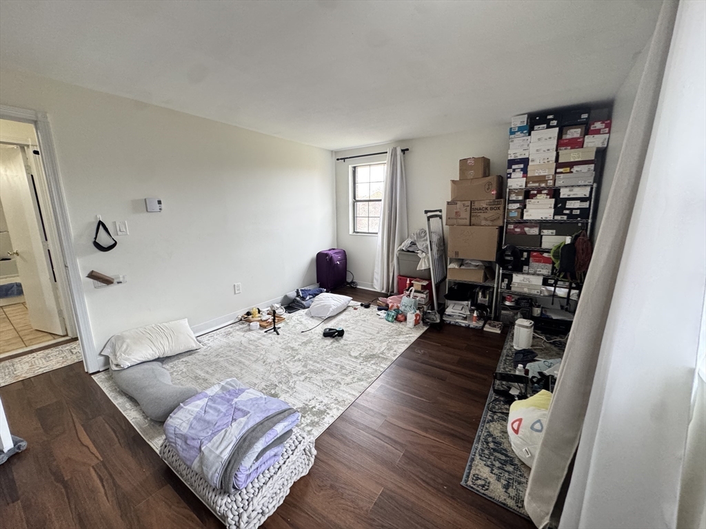 14 A Mayberry Drive, Unit 10 Westborough, MA 01581 - Photo 16 of 25 a bed room with a bed and a book shelf