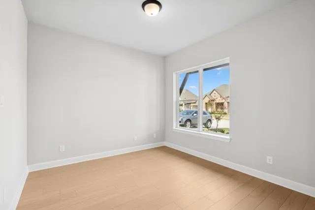 a kitchen with kitchen island granite countertop a sink a stove and refrigerator