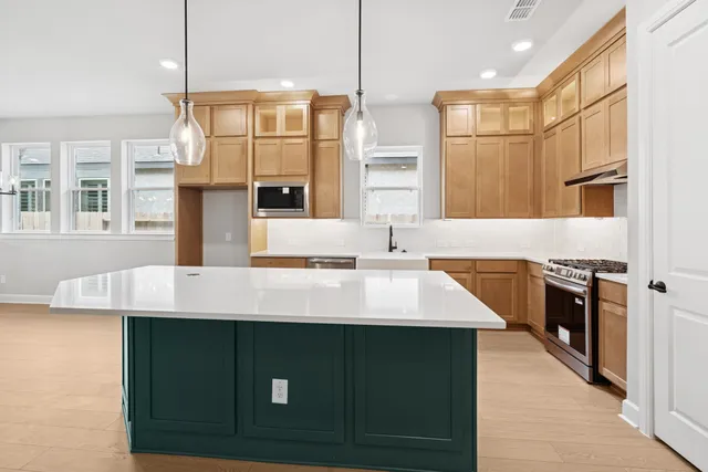 a bathroom with a sink a toilet a mirror a bathtub and shower