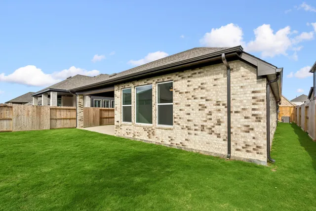 an empty room with windows and chair