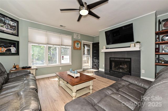 a living room with furniture fireplace and a flat screen tv