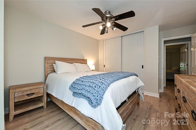 a bedroom with a large bed and a chandelier
