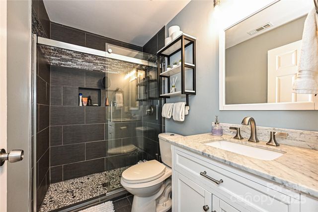 a bathroom with a sink toilet and shower