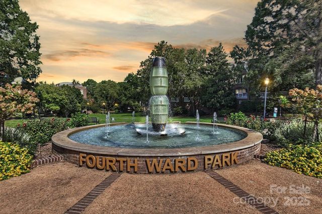 a view of a fountain in the backyard of house