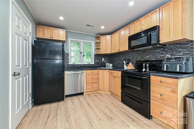 a kitchen with a refrigerator stove top oven and sink