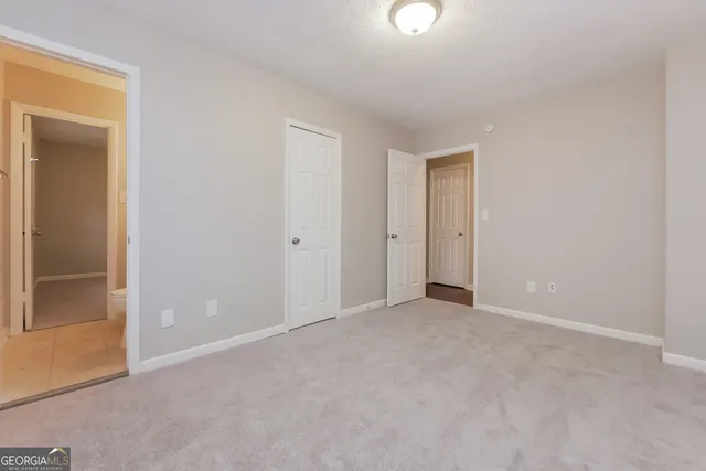 an empty room with closet area