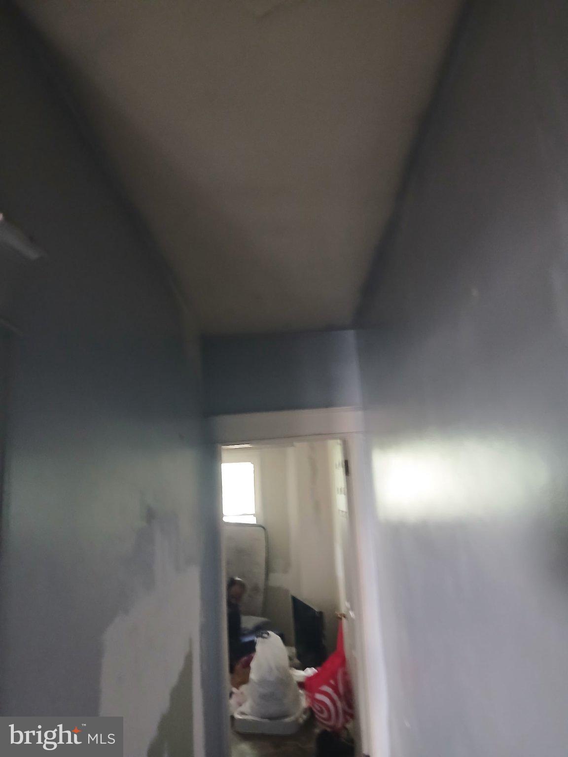 919 Keystone Road Chester, PA 19013 - Photo 4 of 12 Narrow hallway with soft blue tones.