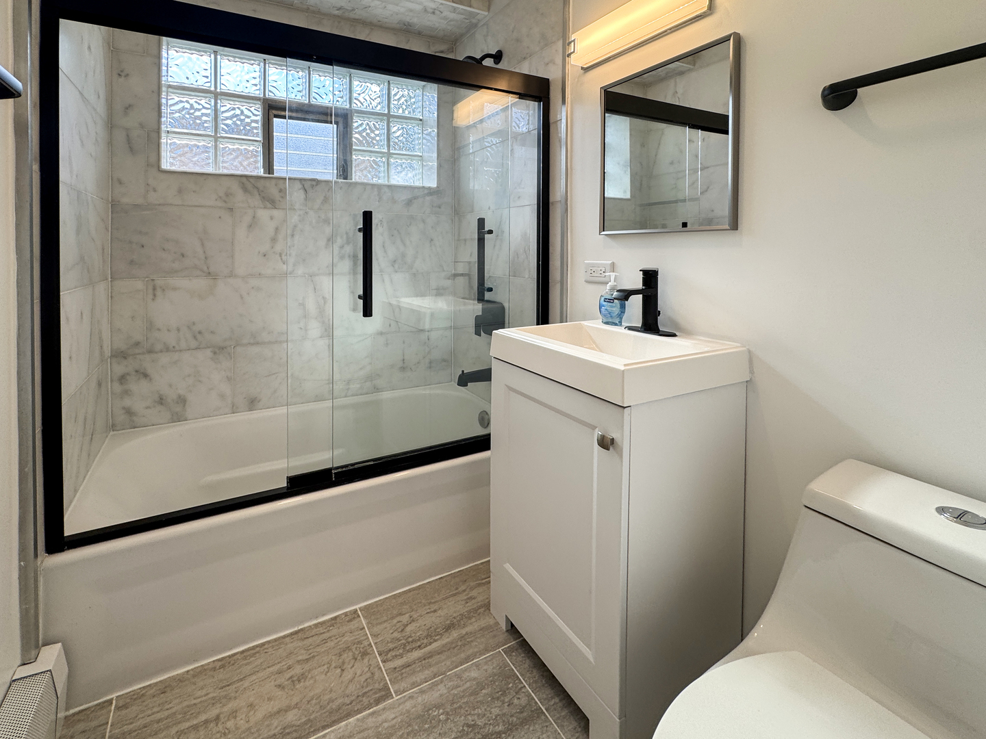 332 North Smith Street, Unit 1 Palatine, IL 60067 - Photo 15 of 17 a bathroom with a sink toilet and shower