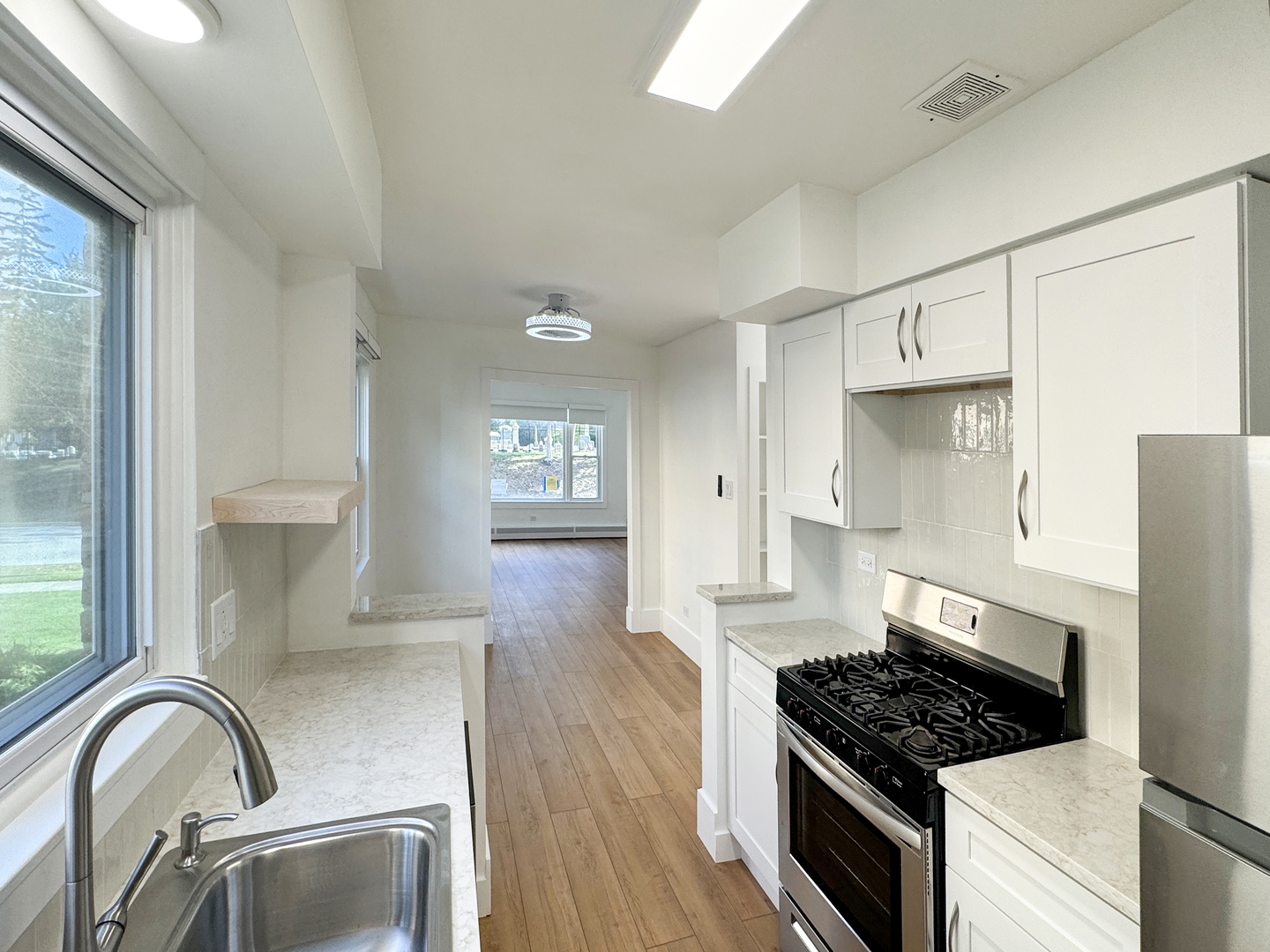 332 North Smith Street, Unit 1 Palatine, IL 60067 - Photo 3 of 17 a kitchen with granite countertop a stove and a refrigerator