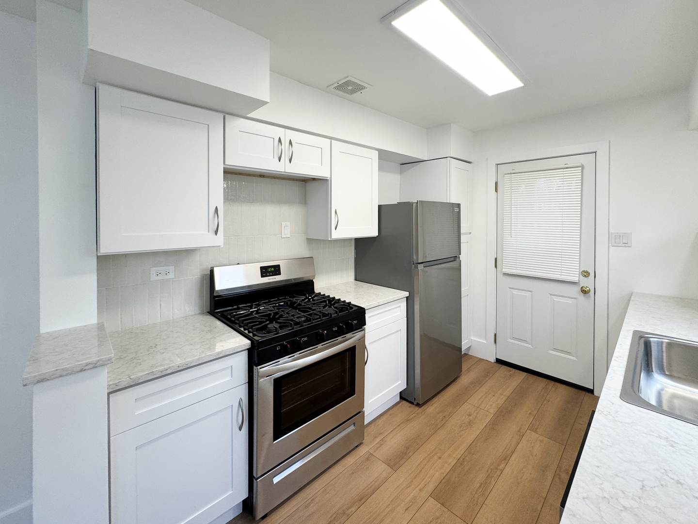 332 North Smith Street, Unit 1 Palatine, IL 60067 - Photo 6 of 17 a kitchen with wooden floors and appliances