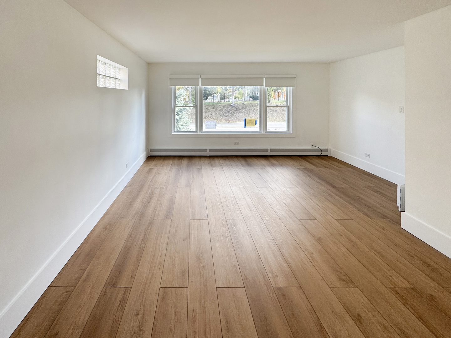 332 North Smith Street, Unit 1 Palatine, IL 60067 - Photo 8 of 17 an empty room with wooden floor and windows