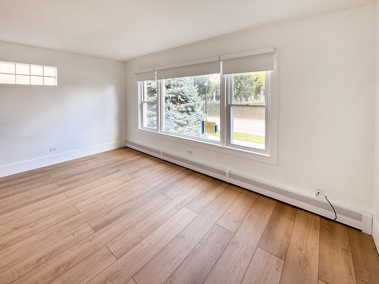 332 North Smith Street, Unit 1 Palatine, IL 60067 - Photo 9 of 17 an empty room with wooden floor and windows