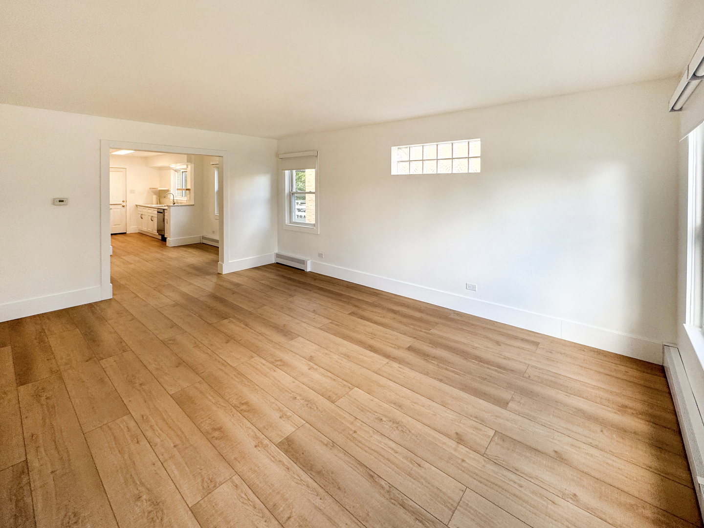 332 North Smith Street, Unit 1 Palatine, IL 60067 - Photo 10 of 17 an empty room with wooden floor and windows