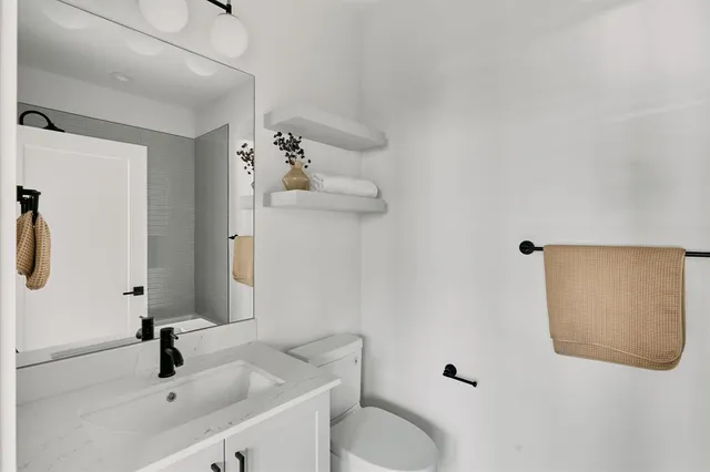 a bathroom with a sink toilet and shower