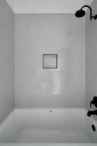 a bathroom with a bathtub and shower