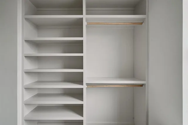 a view of walk in closet with empty racks